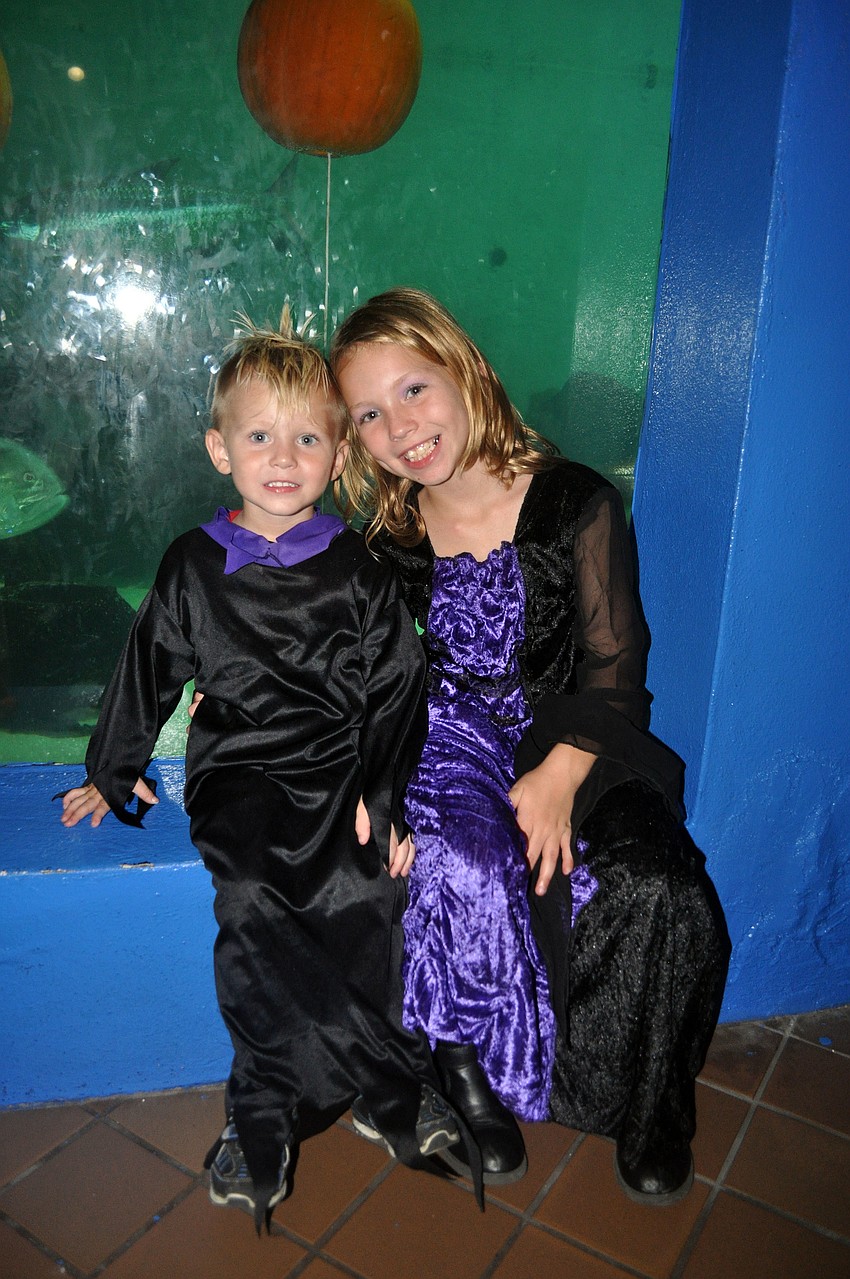 Trent, 2, and Taylor, 8, Callahan wait to see the pumpkin carving in the shark tank at MOTE.
