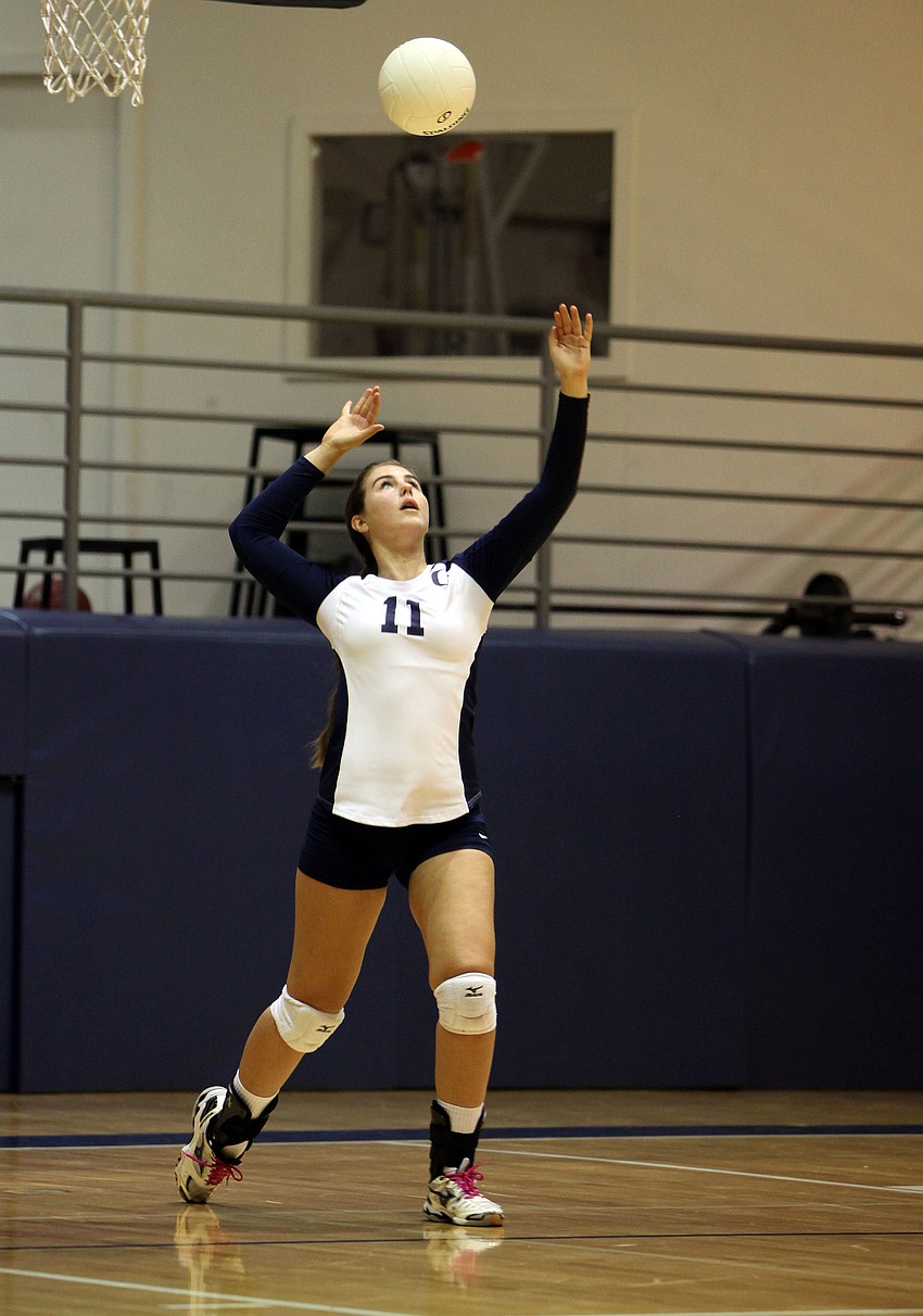 Monica Costa, No. 11, serves up the ball for the Out-of-Door Academy.