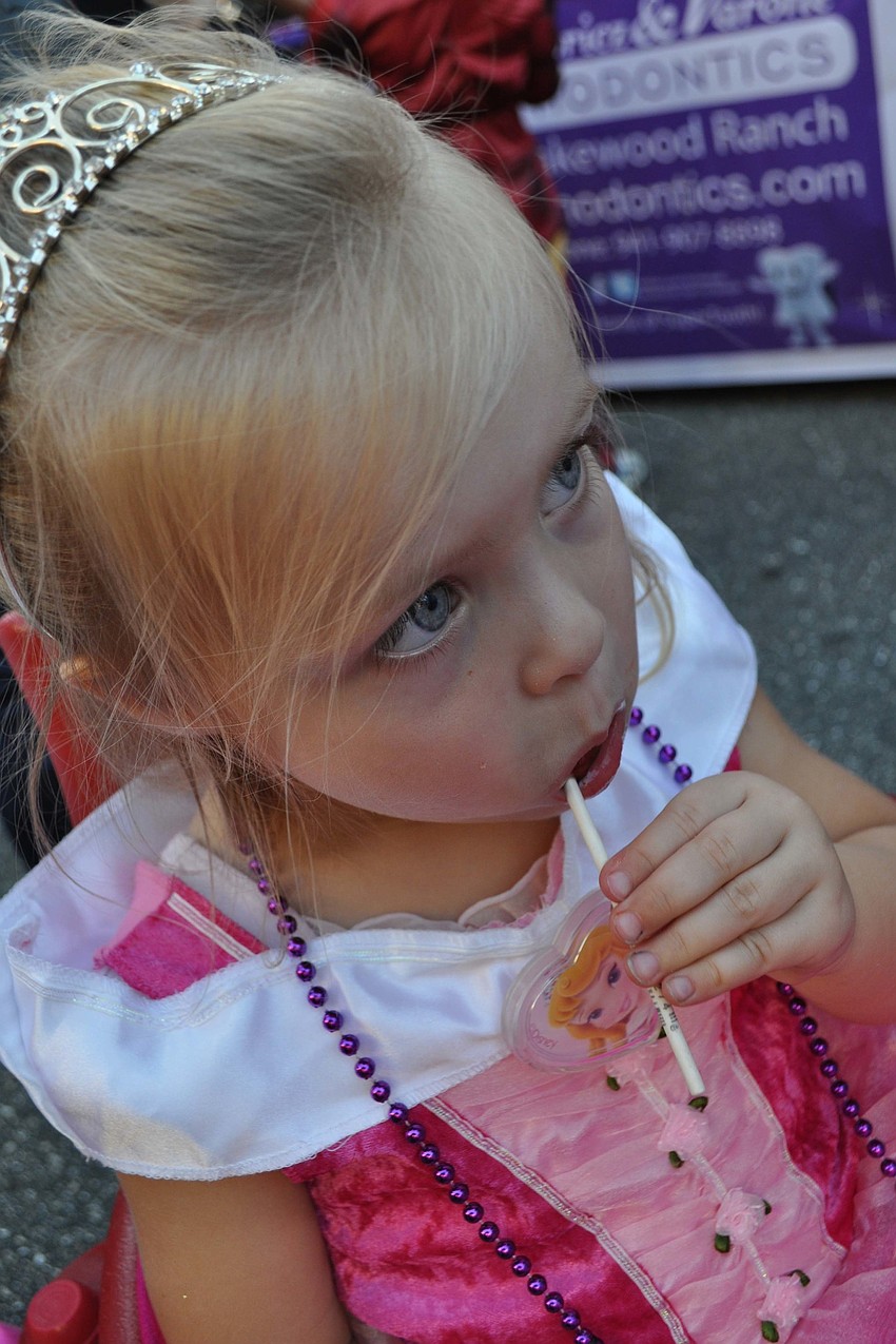 Charlotte Hommez, 3, stayed intent on finishing her lolly pop.