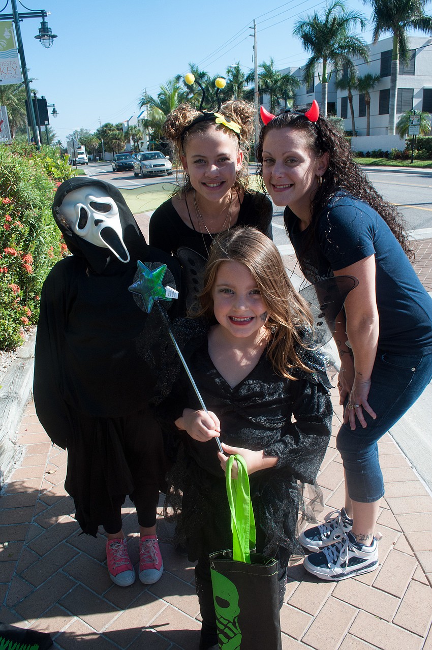 Makayla Homer, Camille Homer and Amiya Hedrick trick-o-treat with mom Carmela Cook.