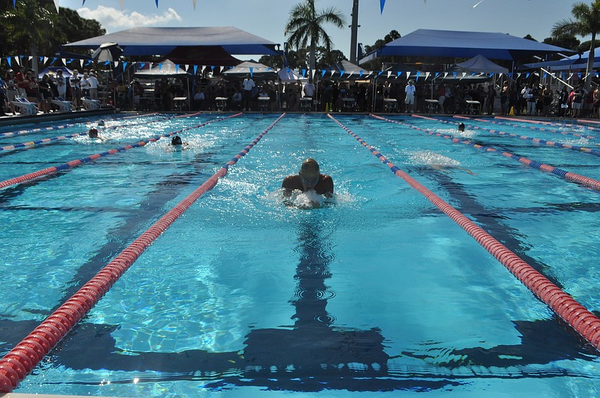 Boys compete in the 100-yard breaststroke.