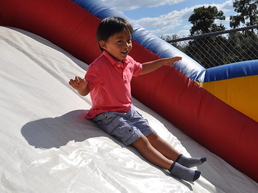 Samuel Oh slid down an inflatable slide.