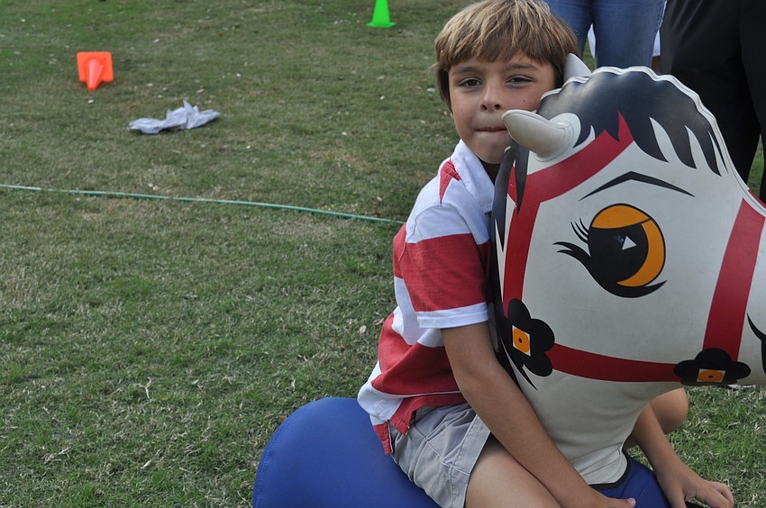 Jackson France rode an inflatable horse.