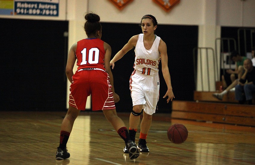 Sarasotaâ€™s Kylie Warner, No. 11, dribbles the ball down the court while Manateeâ€™s Aja Nixon, No. 10, stays on her in hopes of stealing the ball.