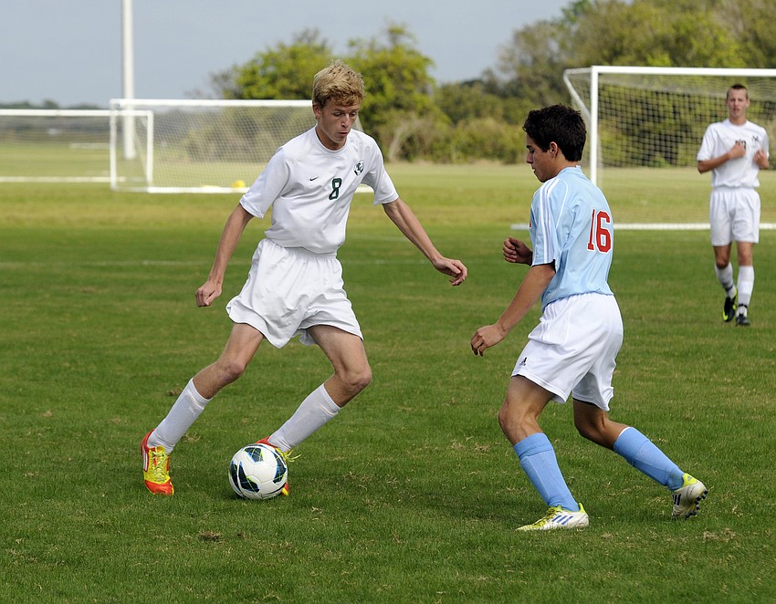 Lakewood Ranchâ€™s Ben Wilson looks to dribble the ball past a Tampa King defender.