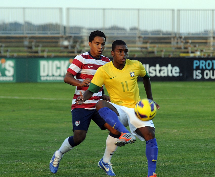 U.S. defender Elijah Martin looks to gain control of the ball from a Brazilian player.