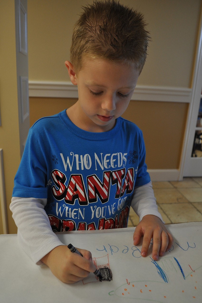 Thomas Bear, 5, practiced his drawing.