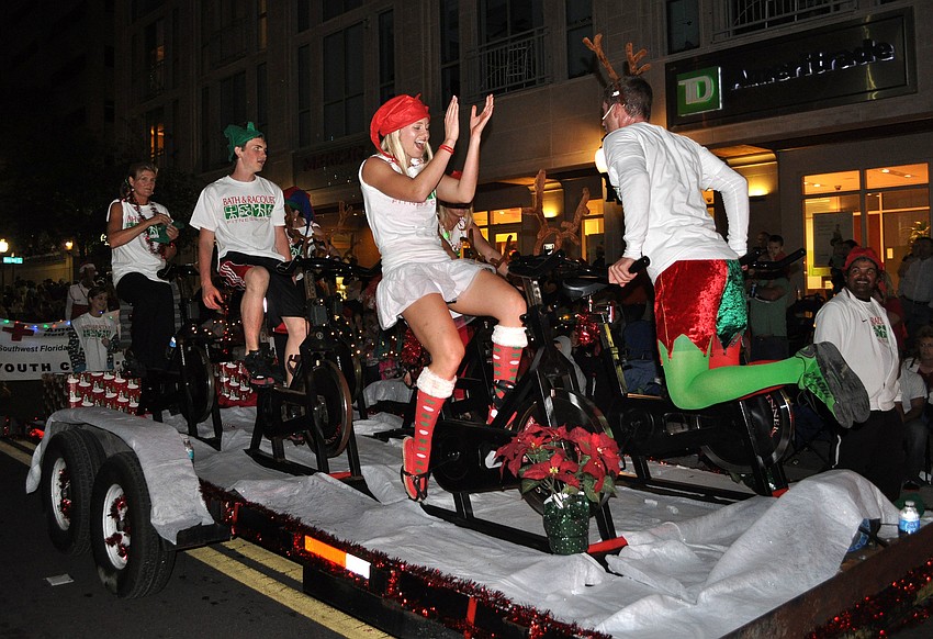 Bath and Racquet employees worked out while riding their float in the parade.