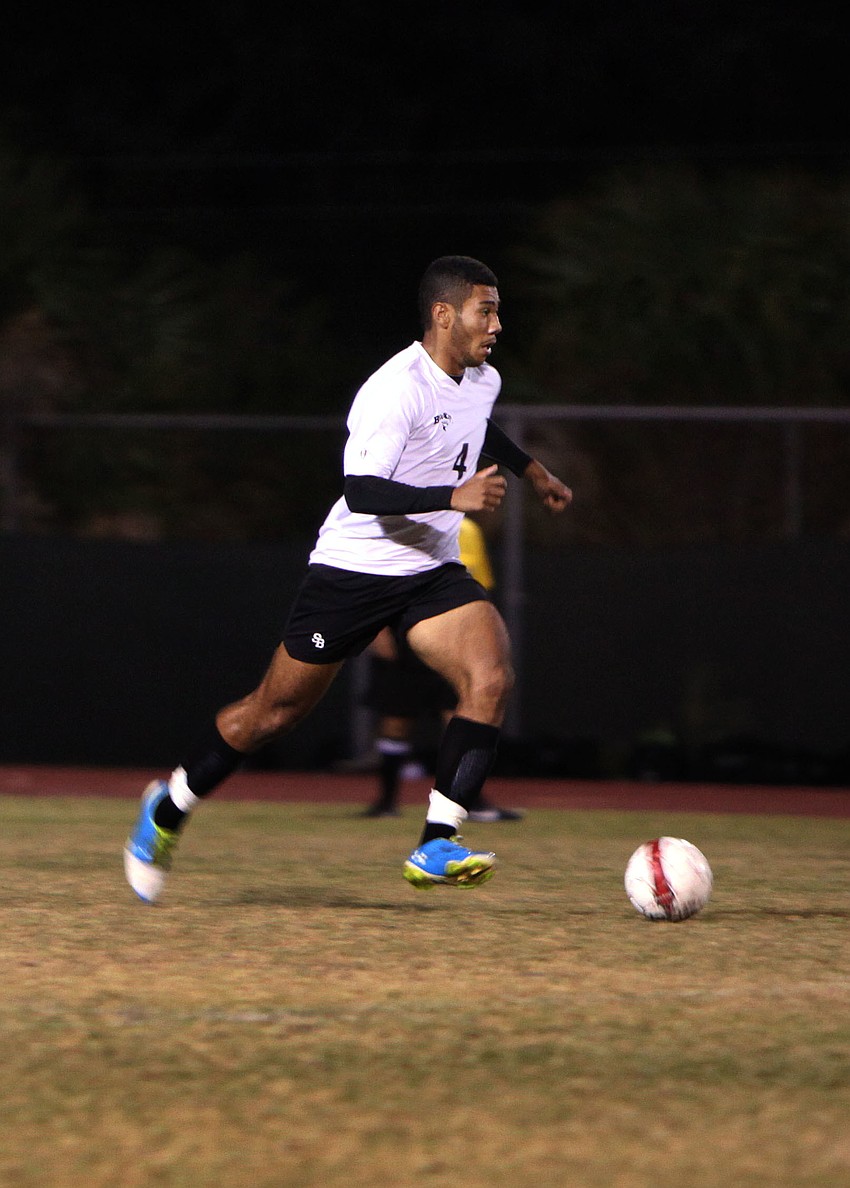 Bookerâ€™s Raul Astakhov, No. 4, heads up the field with the ball.