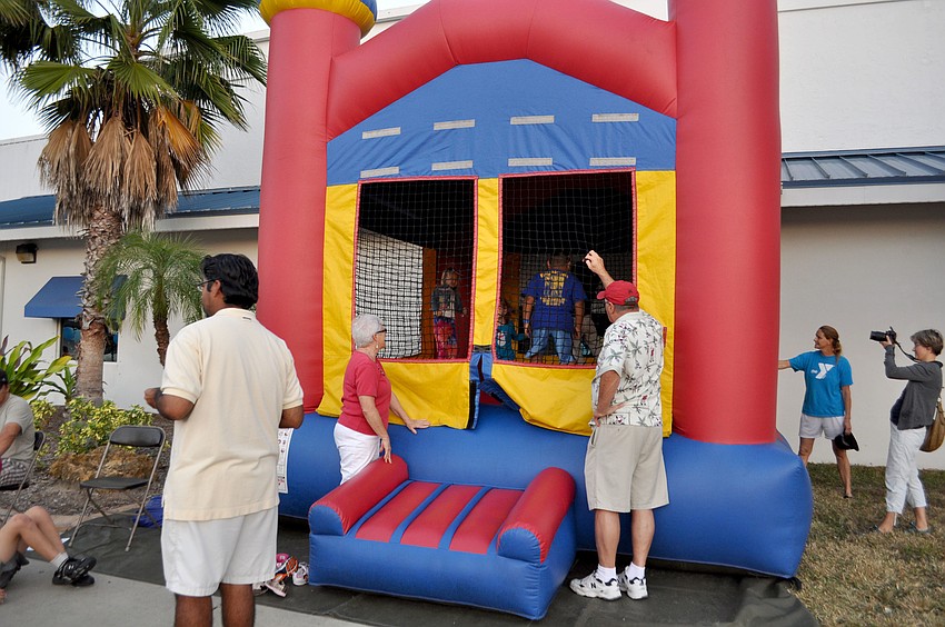 Children jump in an inflatable bounce house