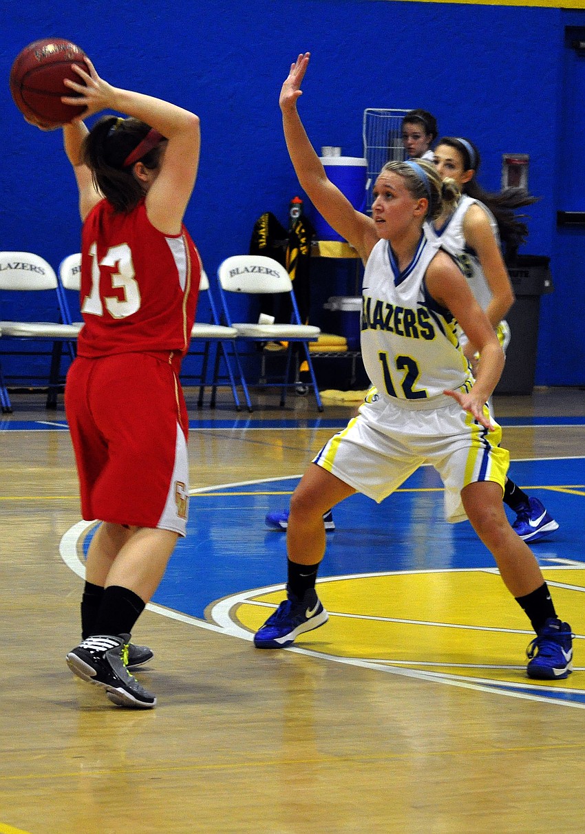 Cardinal Mooneyâ€™s Quinn Incardona, No. 13, tries to pass the ball as Sarasota Christianâ€™s McKenzie Lantz, No. 12, attempts to block her.