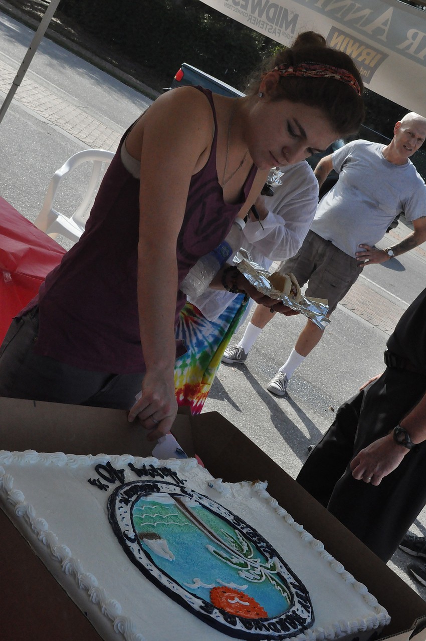 Maggie Acuna slices a piece of cake.
