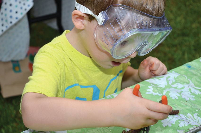 Grant Yeagley makes a wind chime at Art in the Park, a free summer event co-hosted by the Conservation Foundation of the Gulf Coast and Pure Imagination Studios, Aug. 7, at Bay Preserve at Osprey.