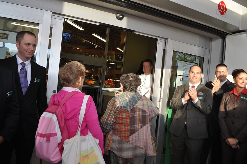 The first customers at the new Longboat Key Publix head through the doors at 8 a.m.
