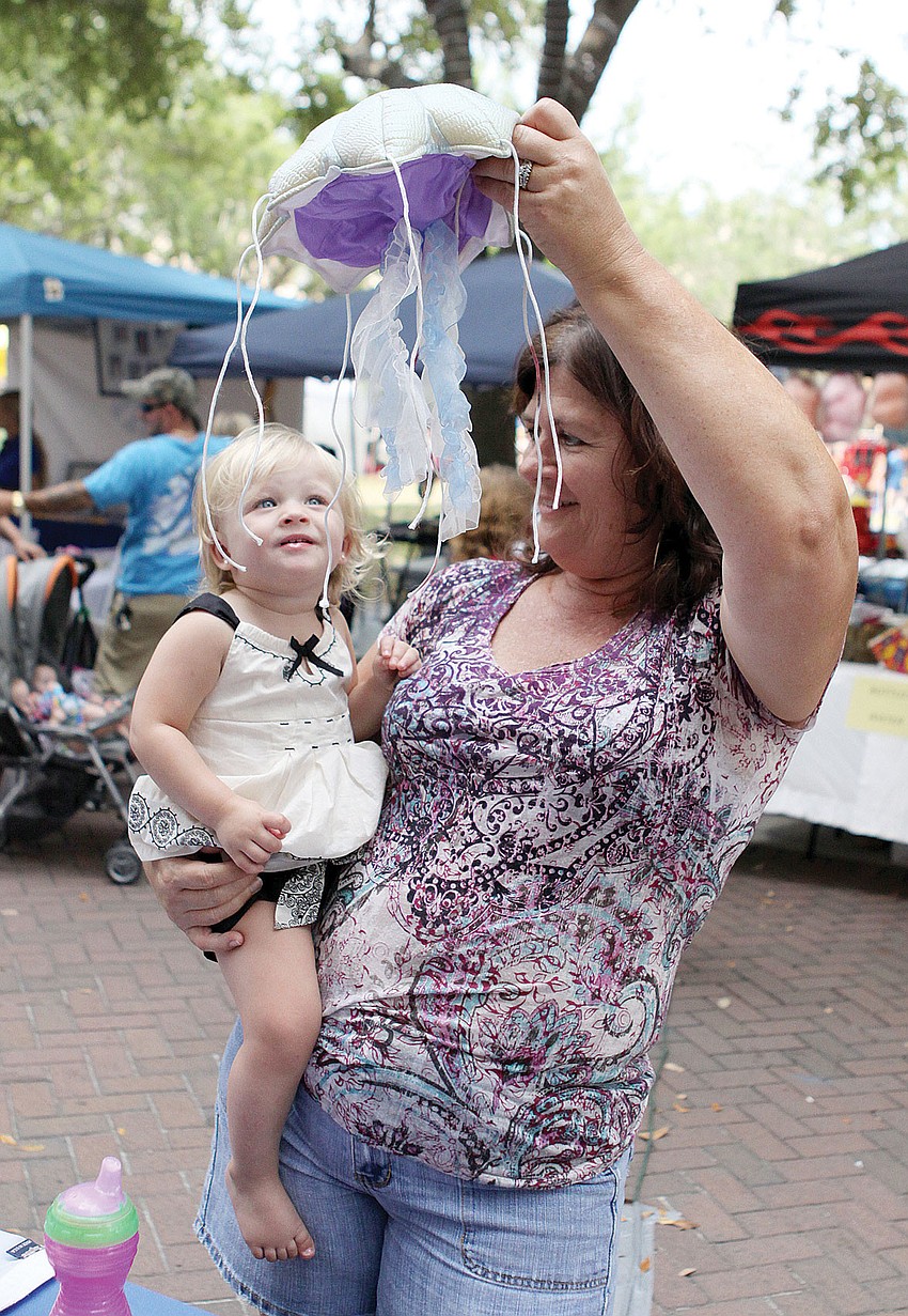 Cindy McRee showed her granddaughter, lena McCree, a stuffed jellyfish from Mote Marine Laboratoryâ€™s table at the 2012 Natural Awakeningsâ€™ EcoFest.