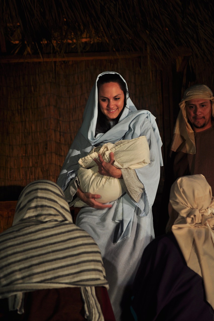 Mary, played by Whitney Kitchens, ponders the birth of her son Jesus, played by Hudson Drake.
