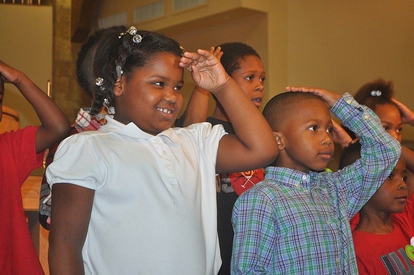 Dejaun Frazier and Jerone Turner mime a kingâ€™s crown while singing â€œThe Little Drummer Boy.â€