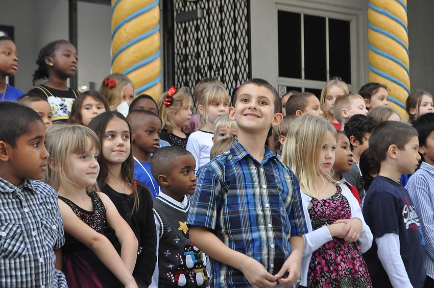 Sean Malo Jr. smiles as his dad snaps his photograph.