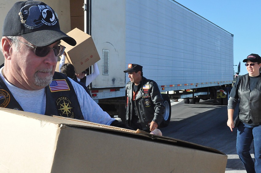Mike Kane helps unload boxes of wreaths.