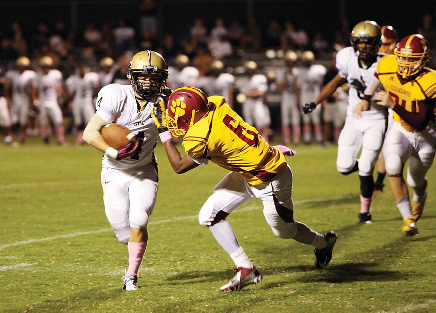 Cardinal Mooney's Sean Morris, No. 6, tries to stop St. Petersburg
Catholicâ€™s Brannon Slater, No. 4. The Cougars played the during their homecoming game at Austin Smithers Stadium. The Cougars won their homecoming game 35-9.