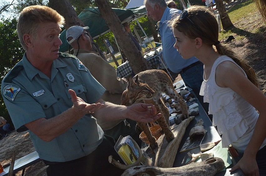 Wendell Vaught gave Emma Griffith a lesson about state parks during the Nov. 17 Sarasota Bay Water Festival at Ken Thompson Park.