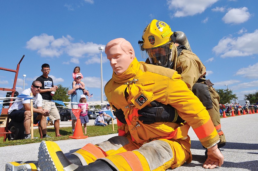 East Manatee Fire Rescueâ€™s Shawn Battick, an engineer, moves a 165-pound life-size mannequin, after completing a rigorous course, at the First Responders Challenge. Published Nov. 15, 2012.