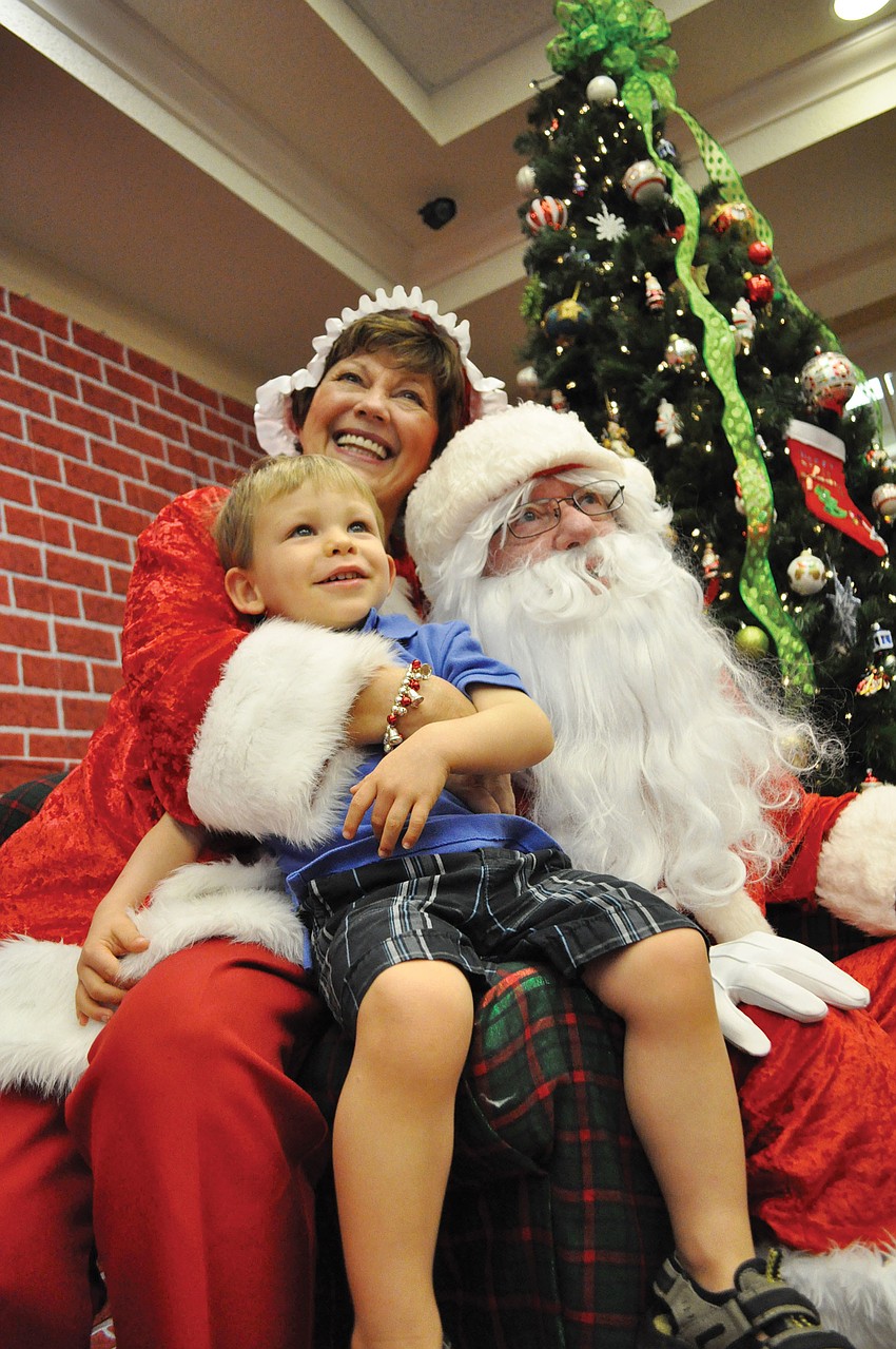 Zachary Roy, 2, smiles during his visit with Mrs. and Mr. Claus, portrayed by Jeanne and John Larranaga, at Heritage Harbour's Breakfast with Santa Dec. 1. Published Dec. 6, 2012.