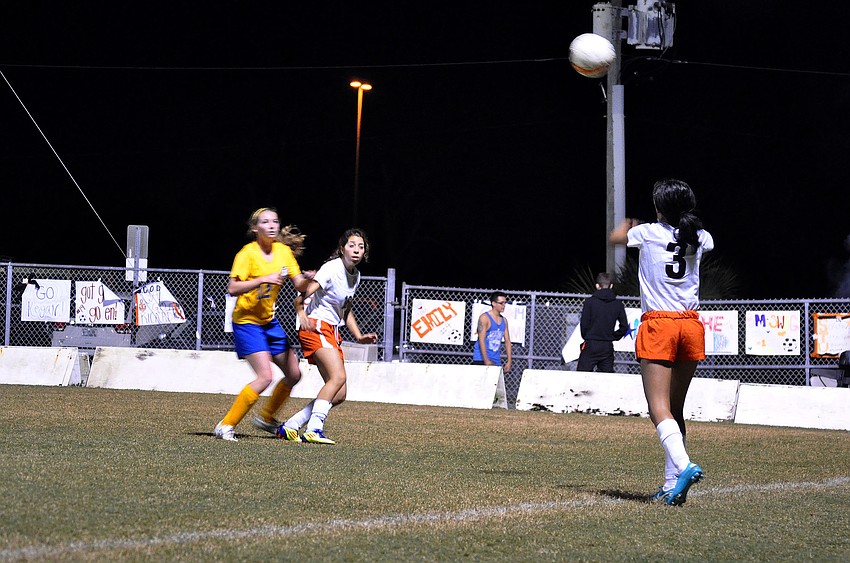 Sarasota High Schoolâ€™s Esmeralda Gonzalez, No. 3, throws the ball in to her teammate Sadie Guttman, No. 16, who was being guarded by Sarasota Military Academyâ€™s Shannon Hunihan, No. 12.