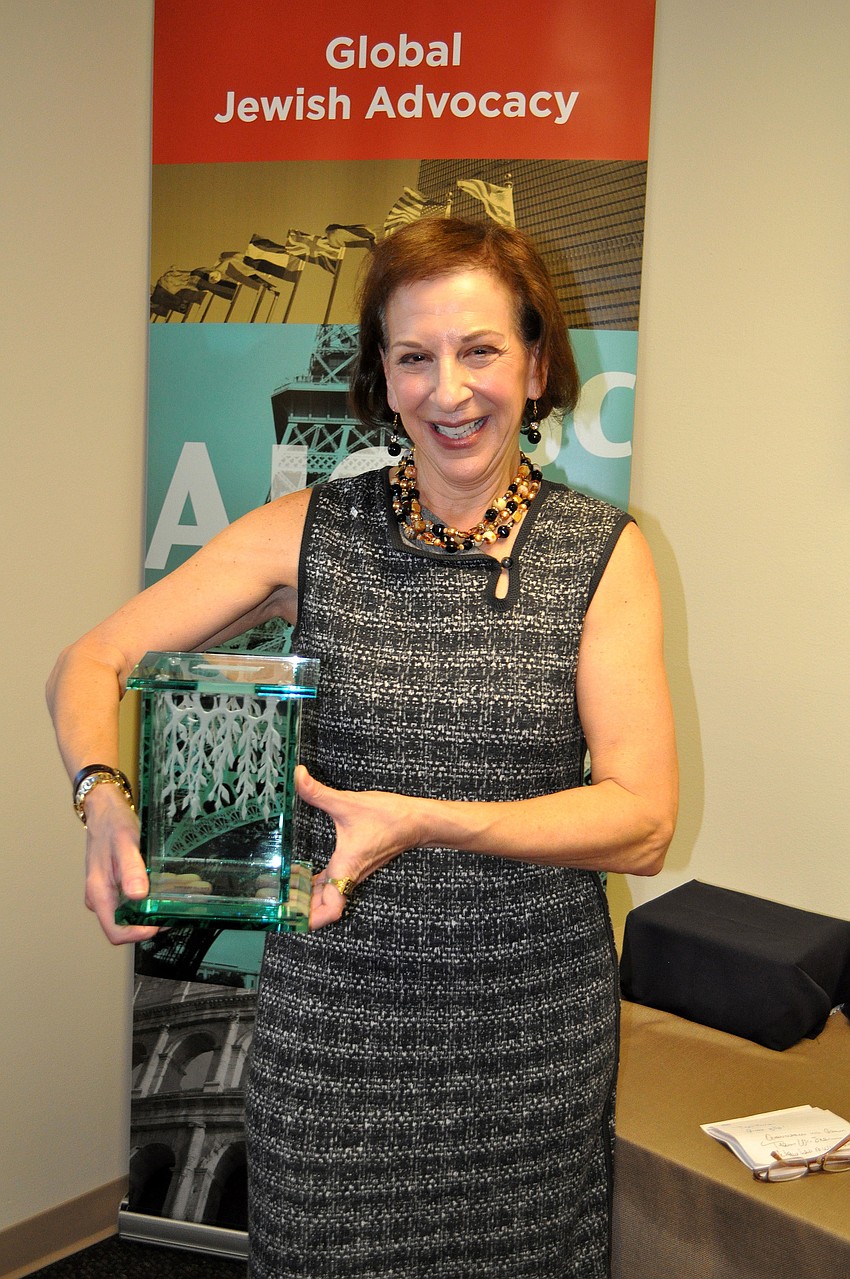 Former AJC West Coast Florida past president Sue Jacobson holds her Tzedakah box â€” a traditional Jewish box that the owner fills with lose change and eventually donates the change to charity.