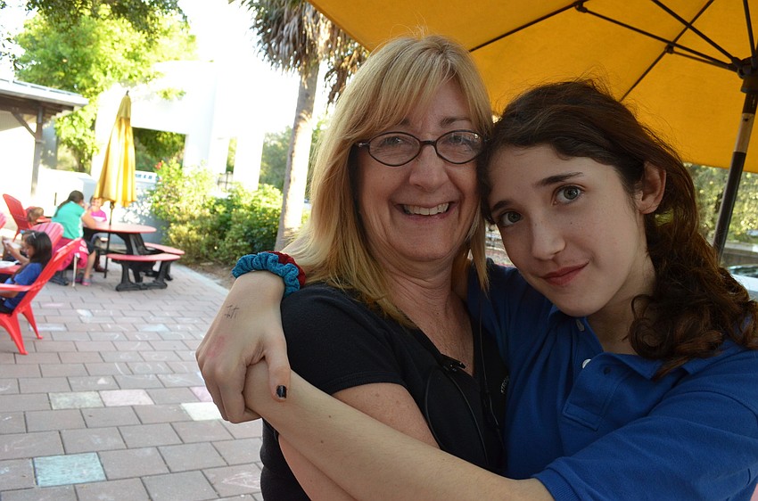 Peggy Graf hugs her granddaughter Caitlin Fritzching who was awarded Citizen of the Month.
