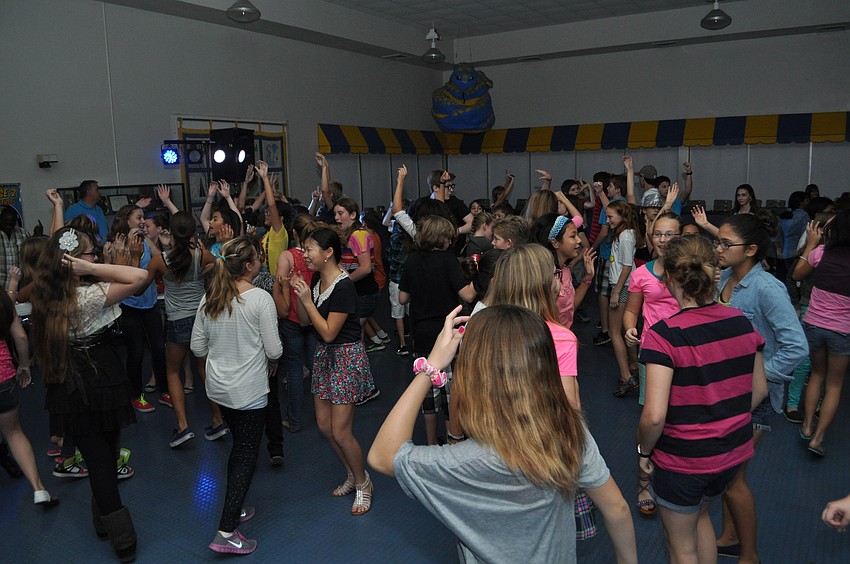 Pine View middle schoolers throw their hands up.