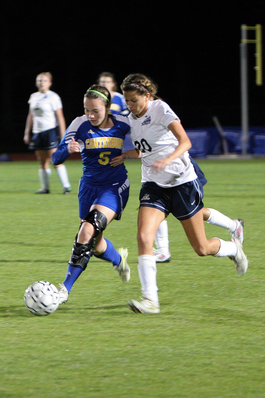 Canterburyâ€™s Courtney Copeland, No. 5, and Out-of-Door Academyâ€™s Juliet Onufrak, No. 20, fight for possession of the ball.