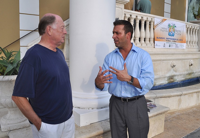 Gary Erickson and Bryan Mobley talk about electric cars Saturday, Sept. 22 during the Electrify the Circle Pre Party at The Met on St. Armands.