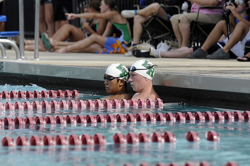 Lakewood Ranchâ€™s Jay Cho and Luke Hanner relax in the cool down lanes after completing the 200-yard individual medley.