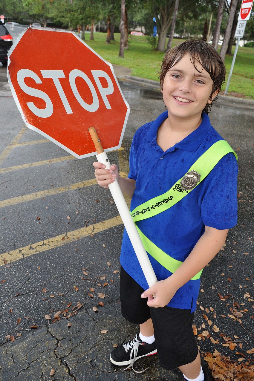 Loukas Wagner, 10, made sure walkers crossed safely on the school campus.