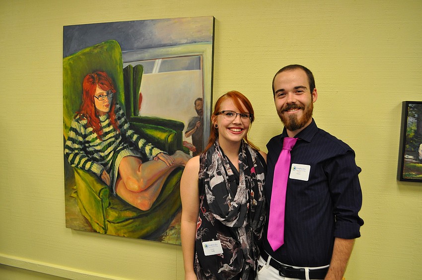 Grace Elizabeth and Scott Prather stand by Pratherâ€™s painting.