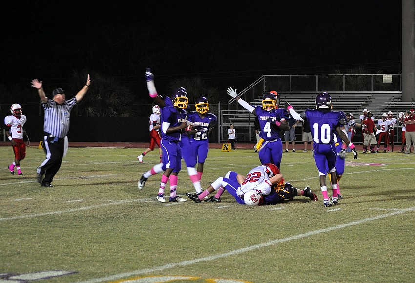 Booker celebrates as NaQuan Loftis intercepts the ball for a turnover.