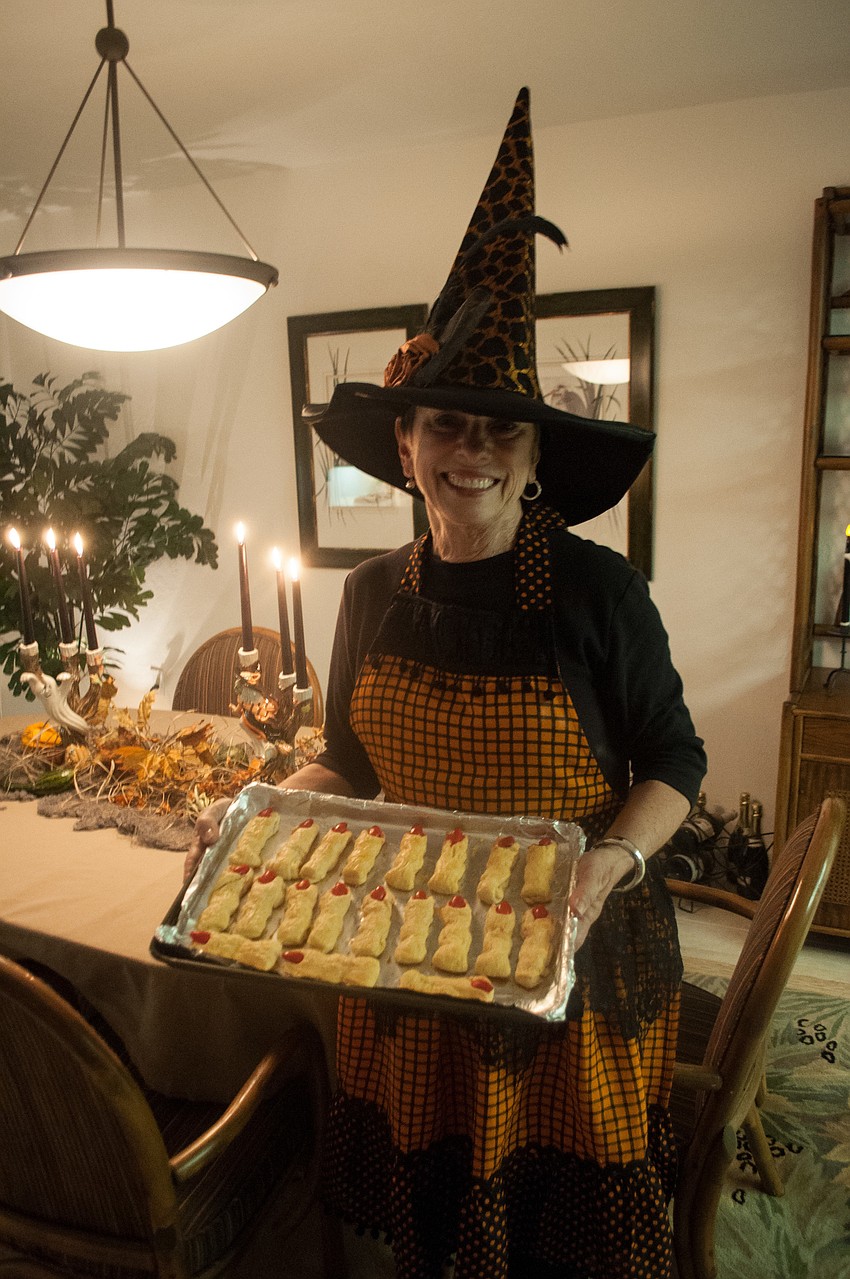 Anne Summers holds a tray of finger food.