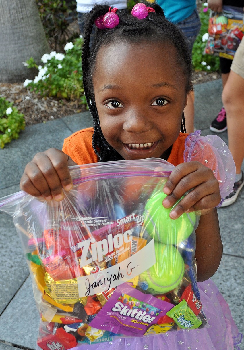 Janiyah Goodman, 5, smiles wide about her overflowing bag of candy.