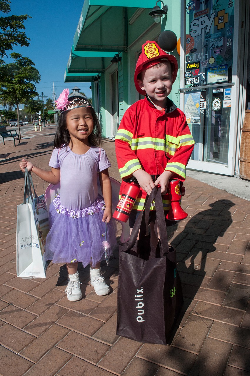Siblings Anna Cate and Michael Barry trick-o-treat on Siesta Key.
