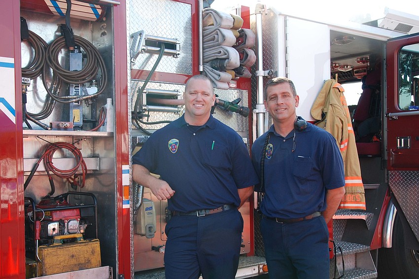 Firefighters Mike Johnson and Scott Rhodes enjoy the event while showing their support for Autism Speaks.