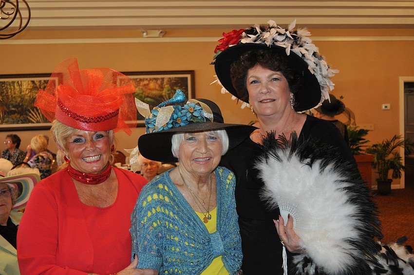 Pat Turdik, who wore her red hat in honor of a Palm-Aire server who has cancer, with Ann Middlecamp and Leslie Kudla