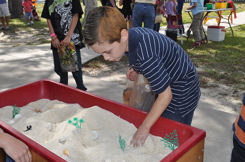 Max Collado dug in a sandbox for a prize.