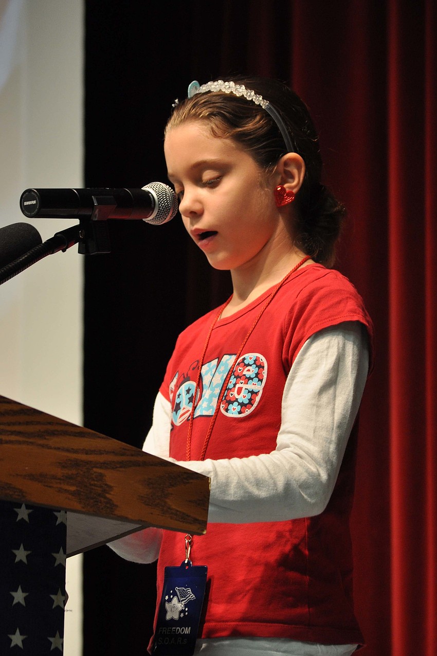 Cadence Bakker, 10, spoke about the history of Veterans Day at at Freedom Elementary's ceremony.