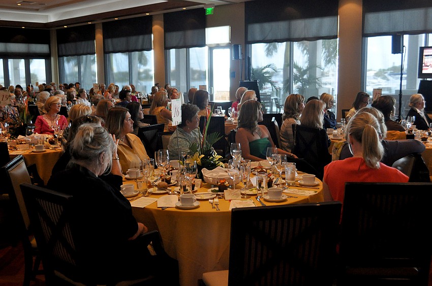 Attendees watch as Ariella Chezar demonstrates floral arrangements.