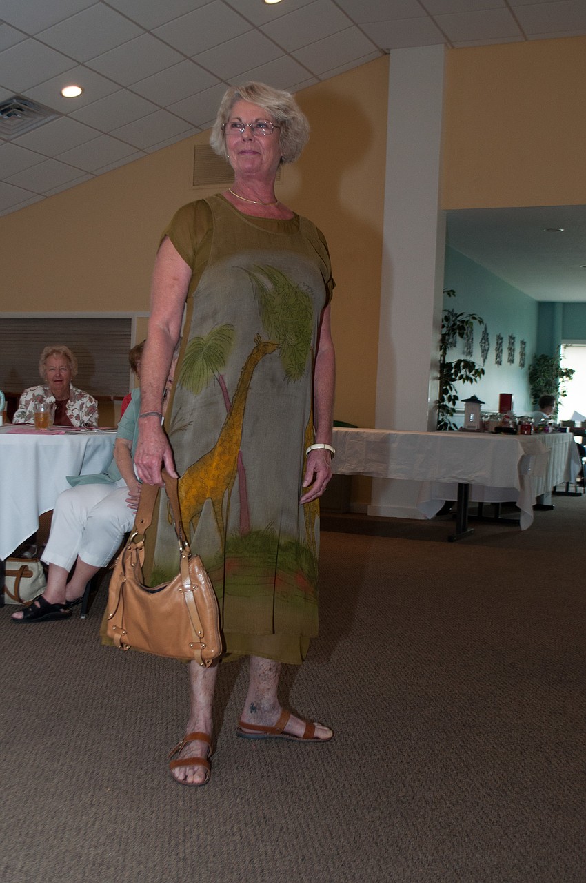 Carola Spillers models a dress with a printed giraffe.