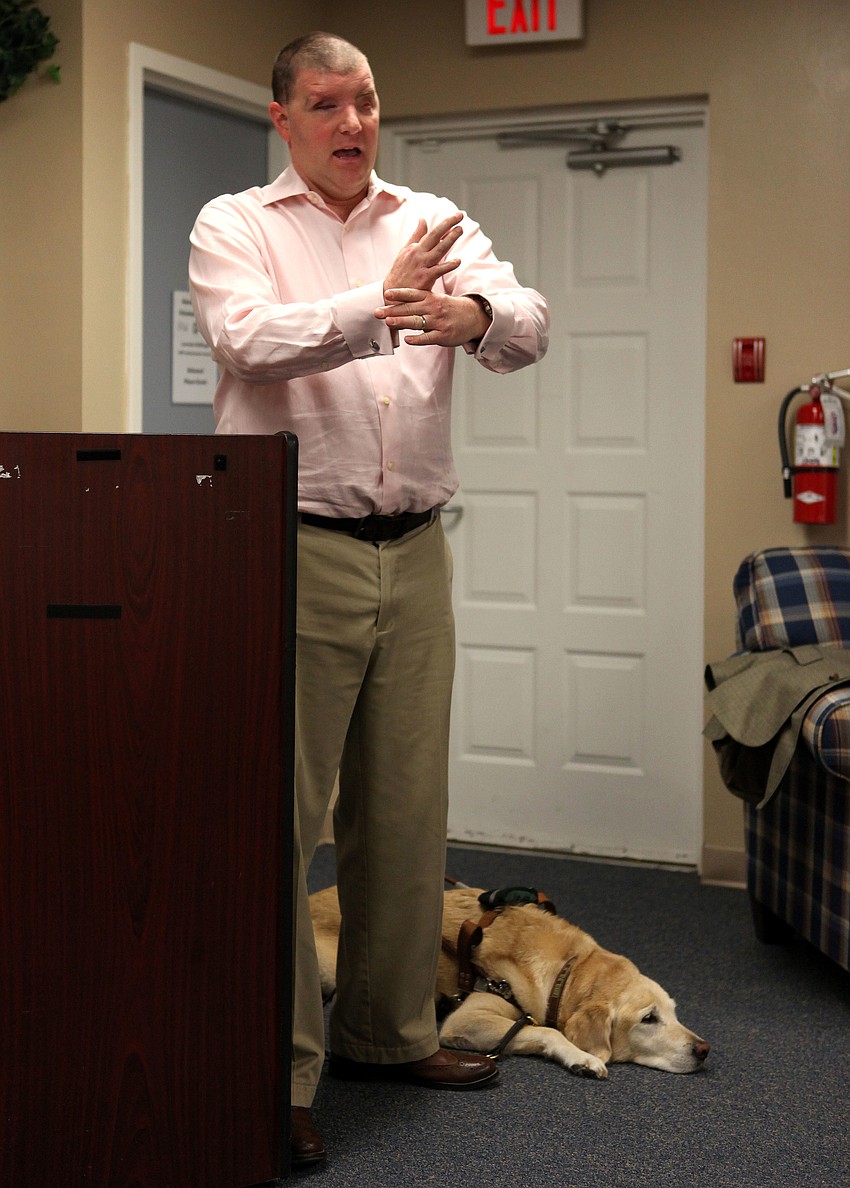 Corporal Michael Jernigan, USMC, Ret. explains how he and Brittani, 8, work together to make sure they stay safe when crossing busy streets.