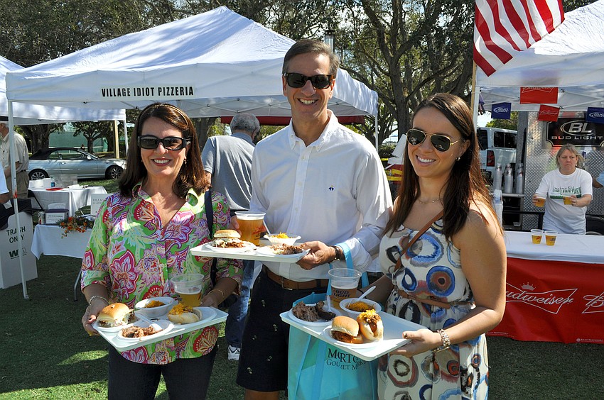 Angela, David and Lea Thierman load up their trays with all sorts of delicious food items from a variety of restaurants that took part in the Longboat Key Gourmet Lawn Party.