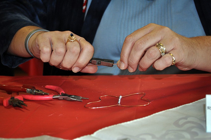 Patti Drake works on making one of her wire creations during the holiday bazaar Saturday, Nov. 17, at Longboat Key Island Chapel.
