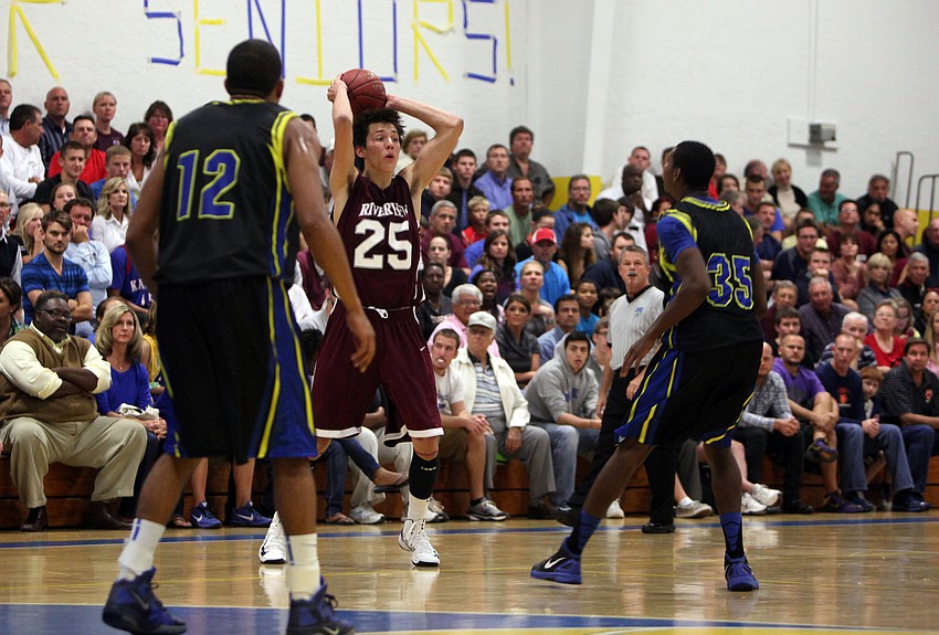 Riverviewâ€™s Nick Havener, No. 25, looks for an open teammate to throw the ball to while being guarded by Sarasota Christianâ€™s Sean Carrigan, No. 12, and Henry Ford, No. 35.